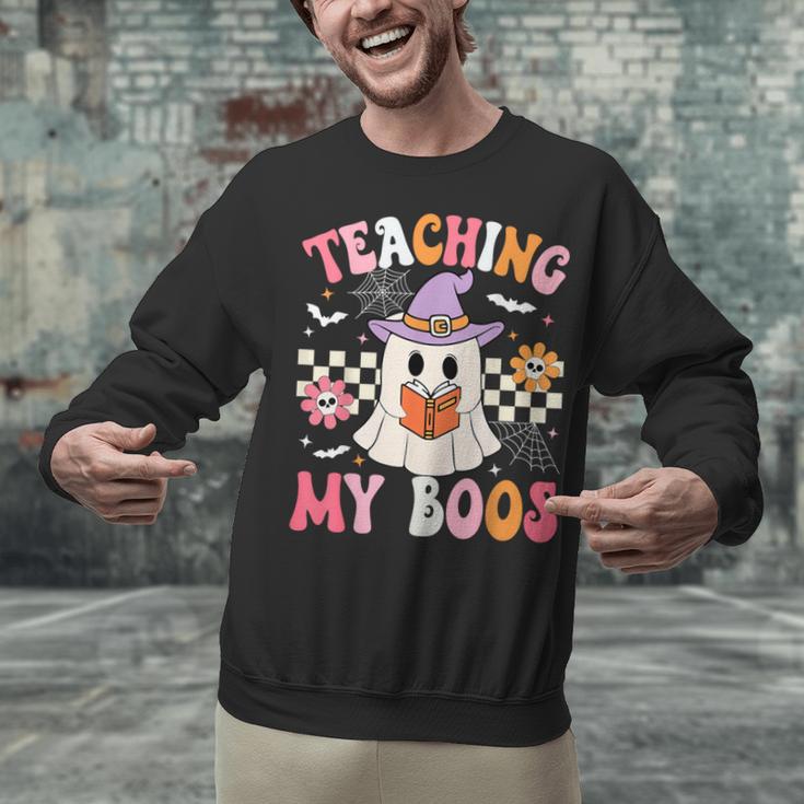 Groovy Teaching My Boos Teacher Ghost Halloween Teacher Unisex Sweatshirt, Groovy Teacher Sweatshirts, gift for family, gift for coworker
