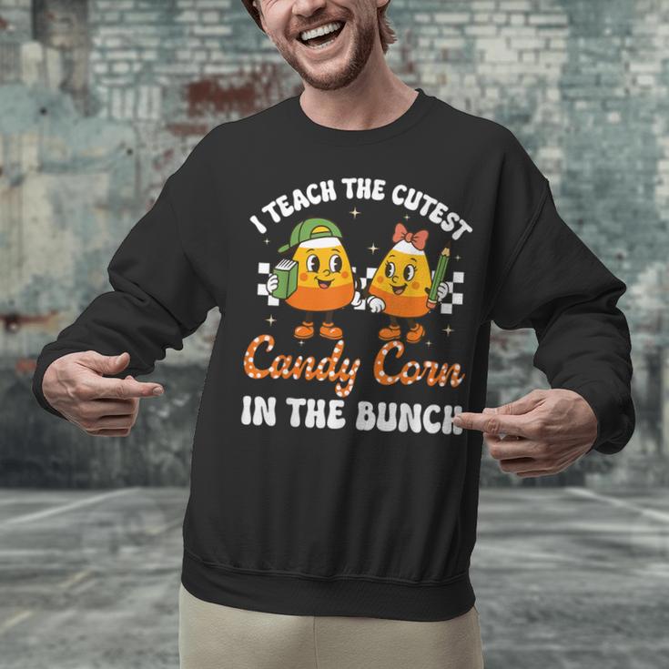 Halloween Teacher Cutest Candy Corn Groovy Spooky Teachers Unisex Sweatshirt, Groovy Teacher Sweatshirts, gift for family, gift for coworker