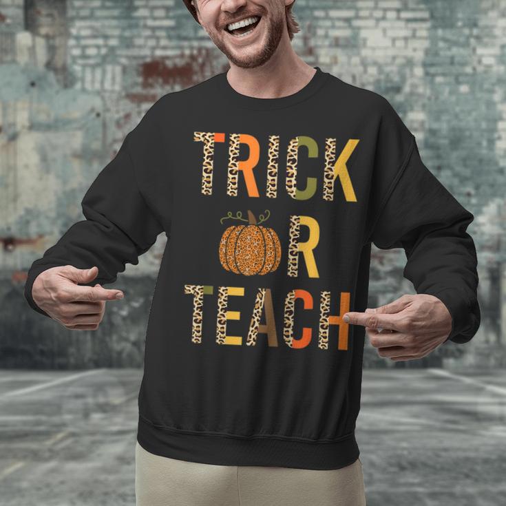 Leopard Trick Or Teach Halloween Teacher Costume Women Unisex Sweatshirt, gift for family, gift for coworker Leopard Trick Or Teach Halloween Teacher Costume Women Unisex Sweatshirt, gift for family, gift for coworker