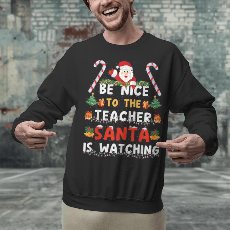Be Nice To The Teacher Santa Is Watching Christmas Unisex Sweatshirt, gift for family, gift for coworker Be Nice To The Teacher Santa Is Watching Christmas Unisex Sweatshirt, gift for family, gift for coworker