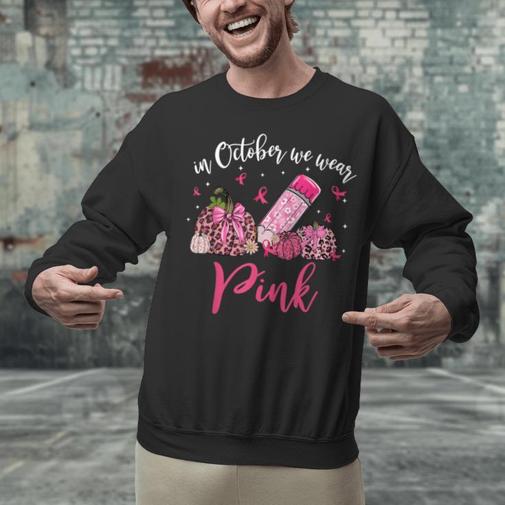 In October We Wear Pink Apple Teacher Daisy Breast Cancer Unisex Sweatshirt, gift for family, gift for coworker