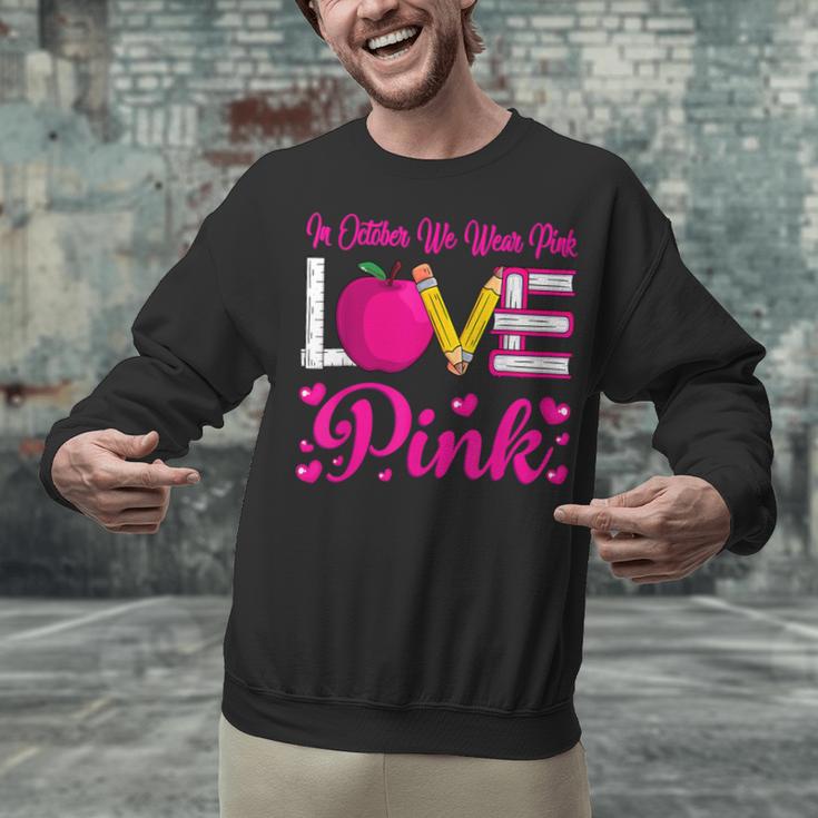 In October We Wear Pink Love Teacher Breast Cancer Awareness Unisex Sweatshirt, gift for family, gift for coworker In October We Wear Pink Love Teacher Breast Cancer Awareness Unisex Sweatshirt, gift for family, gift for coworker