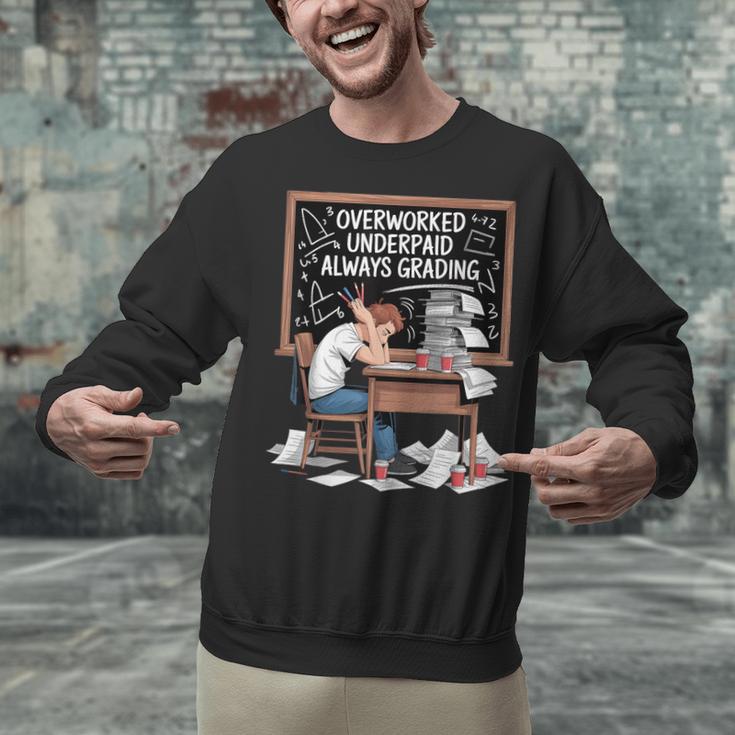 Overworked Underpaid Always Grading Teacher Unisex Sweatshirt, gift for family, gift for coworker Overworked Underpaid Always Grading Teacher Unisex Sweatshirt, gift for family, gift for coworker
