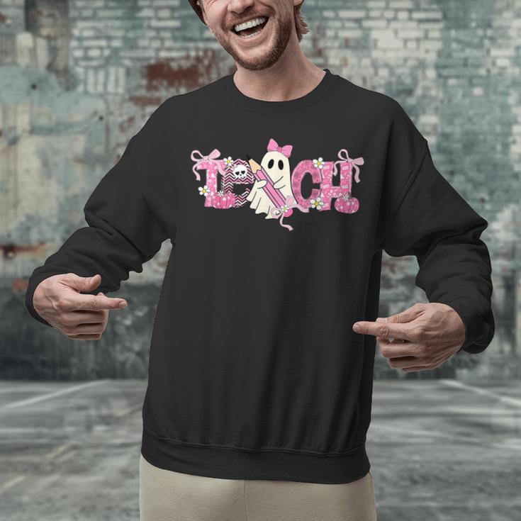 Pink Ghost Teach Halloween Teacher In Spooky Season Unisex Sweatshirt, gift for family, gift for coworker Pink Ghost Teach Halloween Teacher In Spooky Season Unisex Sweatshirt, gift for family, gift for coworker