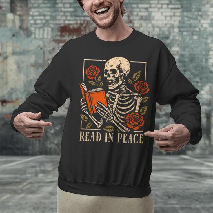 Read In Peace Skeleton Reading Book Halloween Teacher Unisex Sweatshirt, gift for family, gift for coworker Read In Peace Skeleton Reading Book Halloween Teacher Unisex Sweatshirt, gift for family, gift for coworker