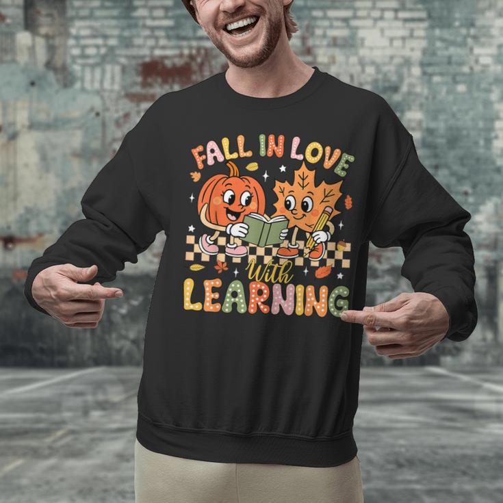 Retro Fall In Love With Learning Autumn Pumpkin Teacher Kids Unisex Sweatshirt, gift for family, gift for coworker Retro Fall In Love With Learning Autumn Pumpkin Teacher Kids Unisex Sweatshirt, gift for family, gift for coworker