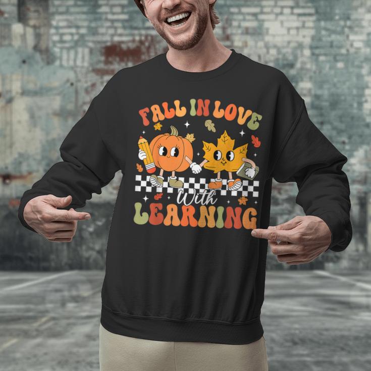 Retro Pumpkin Fall In Love With Learning Autumn Teacher Unisex Sweatshirt, gift for family, gift for coworker Retro Pumpkin Fall In Love With Learning Autumn Teacher Unisex Sweatshirt, gift for family, gift for coworker