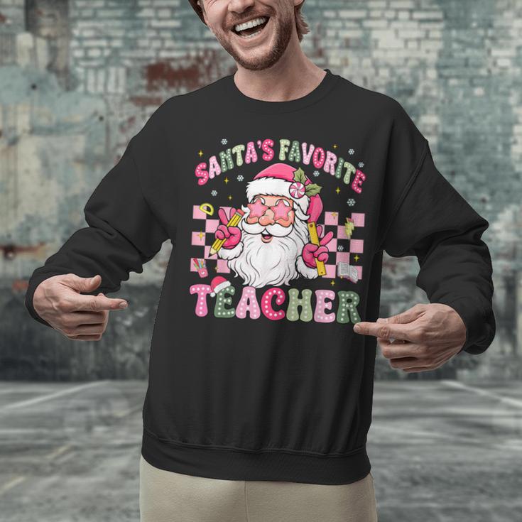 Santa's Favorite Teacher Groovy Christmas Teacher Boys Girls Unisex Sweatshirt, Groovy Teacher Sweatshirts, gift for family, gift for coworker Santa's Favorite Teacher Groovy Christmas Teacher Boys Girls Unisex Sweatshirt, Groovy Teacher Sweatshirts, gift for family, gift for coworker
