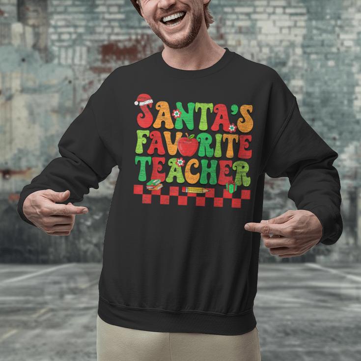 Santas Favorite Teacher Retro Groovy Christmas Xmas Women Unisex Sweatshirt, Groovy Teacher Sweatshirts, gift for family, gift for coworker Santas Favorite Teacher Retro Groovy Christmas Xmas Women Unisex Sweatshirt, Groovy Teacher Sweatshirts, gift for family, gift for coworker