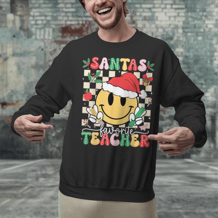 Santas Favorite Teacher Retro Groovy Smile Face Christmas Unisex Sweatshirt, Groovy Teacher Sweatshirts, gift for family, gift for coworker Santas Favorite Teacher Retro Groovy Smile Face Christmas Unisex Sweatshirt, Groovy Teacher Sweatshirts, gift for family, gift for coworker