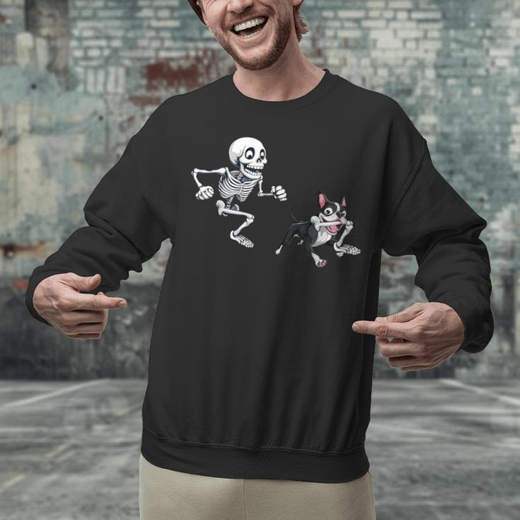 Skeleton Chasing Dog Boston Terrier Halloween Pet Lover Unisex Sweatshirt, Boston Terrier Halloween Sweatshirts, gift for family, gift for coworker