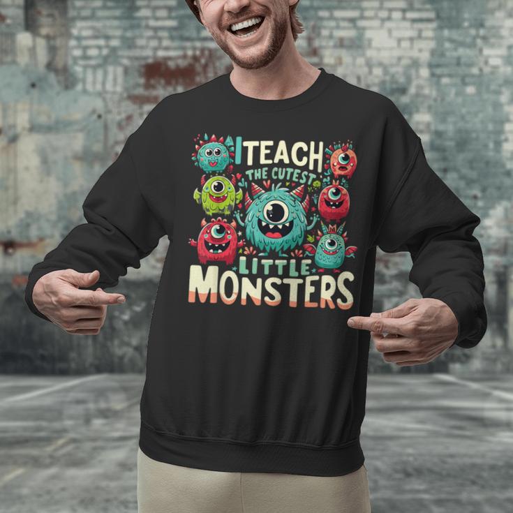 I Teach The Cutest Little Monsters Teacher Halloween Outfit Unisex Sweatshirt, gift for family, gift for coworker I Teach The Cutest Little Monsters Teacher Halloween Outfit Unisex Sweatshirt, gift for family, gift for coworker