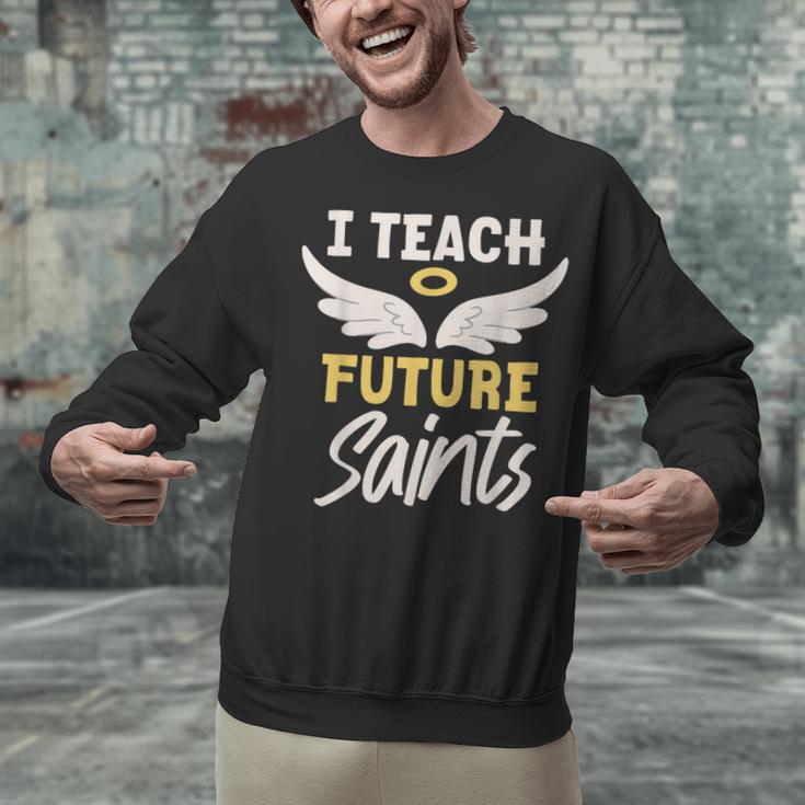 I Teach Future Saints Catholic Educator Teacher Unisex Sweatshirt, Future Teacher Sweatshirts, gift for family, gift for coworker I Teach Future Saints Catholic Educator Teacher Unisex Sweatshirt, Future Teacher Sweatshirts, gift for family, gift for coworker