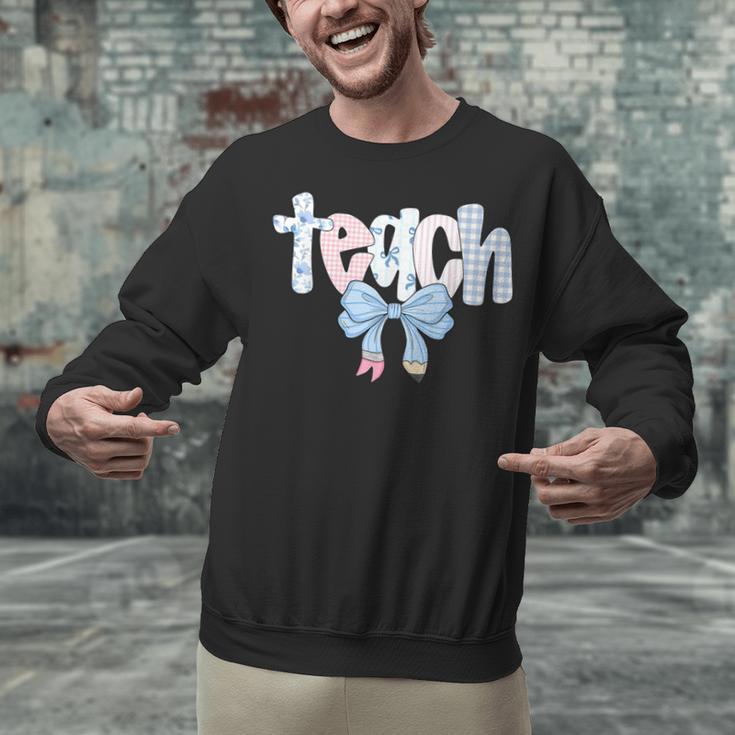 Teach Teacher Coquette Bow Pencil Back To School First Day Unisex Sweatshirt, gift for family, gift for coworker Teach Teacher Coquette Bow Pencil Back To School First Day Unisex Sweatshirt, gift for family, gift for coworker