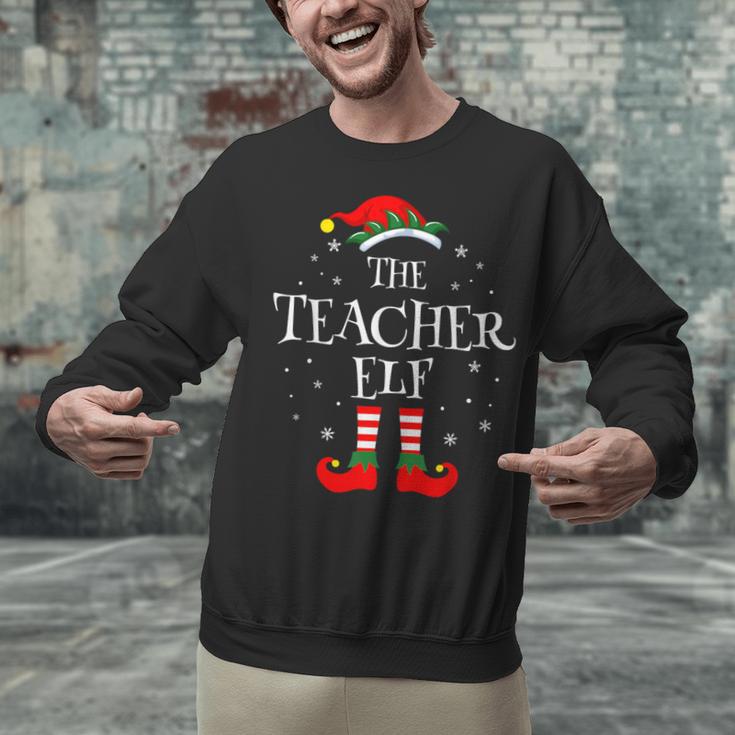 The Teacher Elf Christmas Family Matching Group Xmas Unisex Sweatshirt, gift for family, gift for coworker The Teacher Elf Christmas Family Matching Group Xmas Unisex Sweatshirt, gift for family, gift for coworker