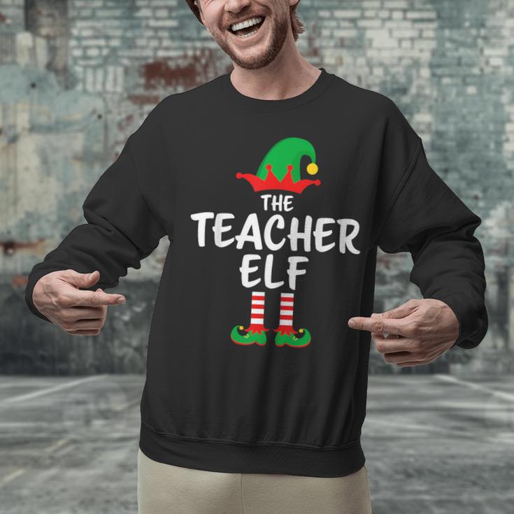 The Teacher Elf Matching Family Christmas Unisex Sweatshirt, gift for family, gift for coworker The Teacher Elf Matching Family Christmas Unisex Sweatshirt, gift for family, gift for coworker
