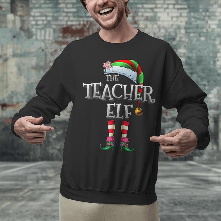 The Teacher Elf Shirt Matching Family Christmas Elf Men Women Kids Unisex Sweatshirt, gift for family, gift for coworker The Teacher Elf Shirt Matching Family Christmas Elf Men Women Kids Unisex Sweatshirt, gift for family, gift for coworker