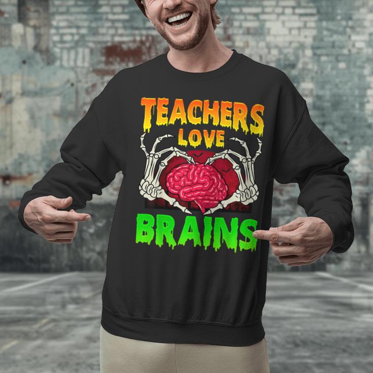 Teacher Teachers Love Brains Skeleton Hand Heart Halloween Unisex Sweatshirt, gift for family, gift for coworker Teacher Teachers Love Brains Skeleton Hand Heart Halloween Unisex Sweatshirt, gift for family, gift for coworker