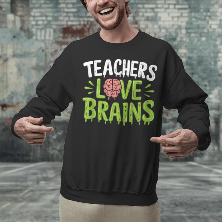 Teachers Love Brains Halloween Teacher Zombie Unisex Sweatshirt, gift for family, gift for coworker Teachers Love Brains Halloween Teacher Zombie Unisex Sweatshirt, gift for family, gift for coworker