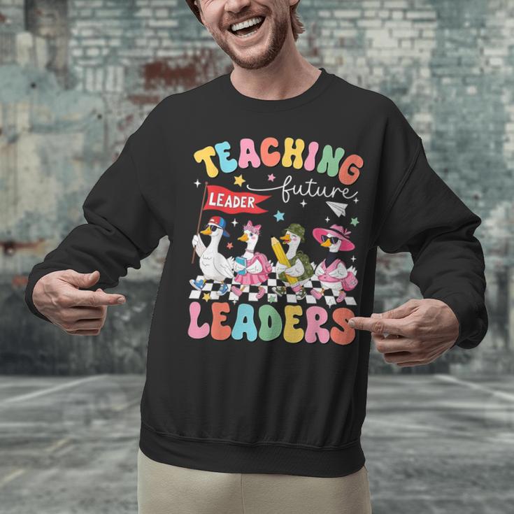 Teaching Future Leaders Groovy Teacher Back To School Unisex Sweatshirt, Future Teacher Sweatshirts, Groovy Teacher Sweatshirts, gift for family, gift for coworker