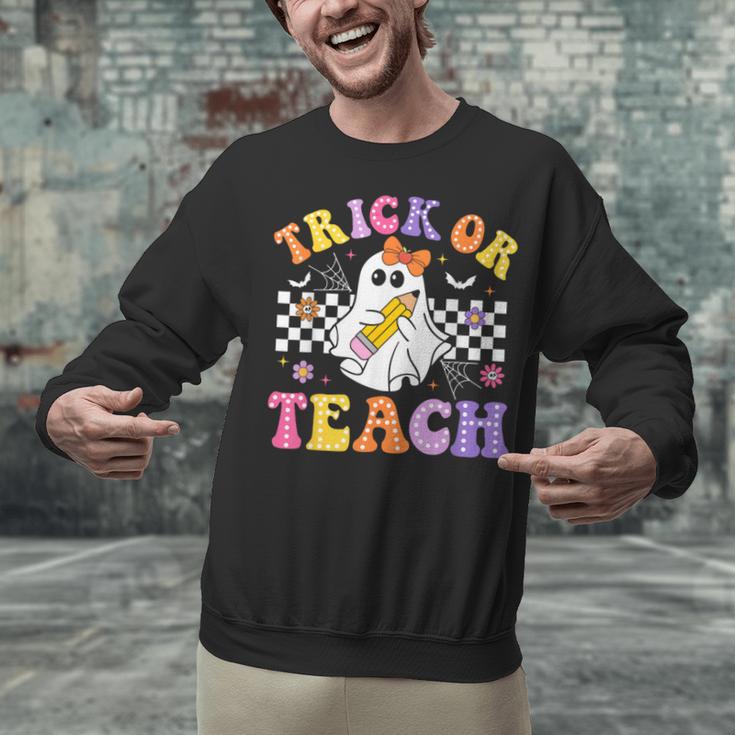 Trick Or Teach Groovy Halloween Teachers Unisex Sweatshirt, gift for family, gift for coworker Trick Or Teach Groovy Halloween Teachers Unisex Sweatshirt, gift for family, gift for coworker