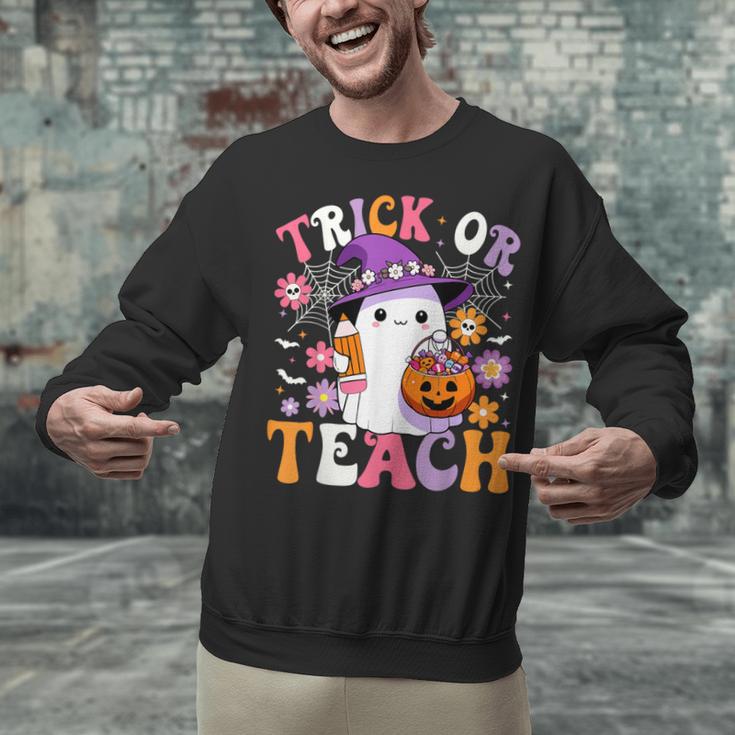 Trick Or Teach Groovy Teacher Ghost Halloween Teacher Unisex Sweatshirt, Groovy Teacher Sweatshirts, gift for family, gift for coworker