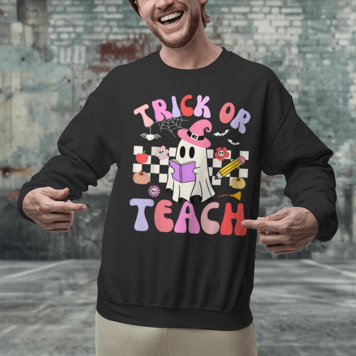 Trick Or Teach Halloween Teacher Floral Ghost Groovy Unisex Sweatshirt, Groovy Teacher Sweatshirts, gift for family, gift for coworker Trick Or Teach Halloween Teacher Floral Ghost Groovy Unisex Sweatshirt, Groovy Teacher Sweatshirts, gift for family, gift for coworker