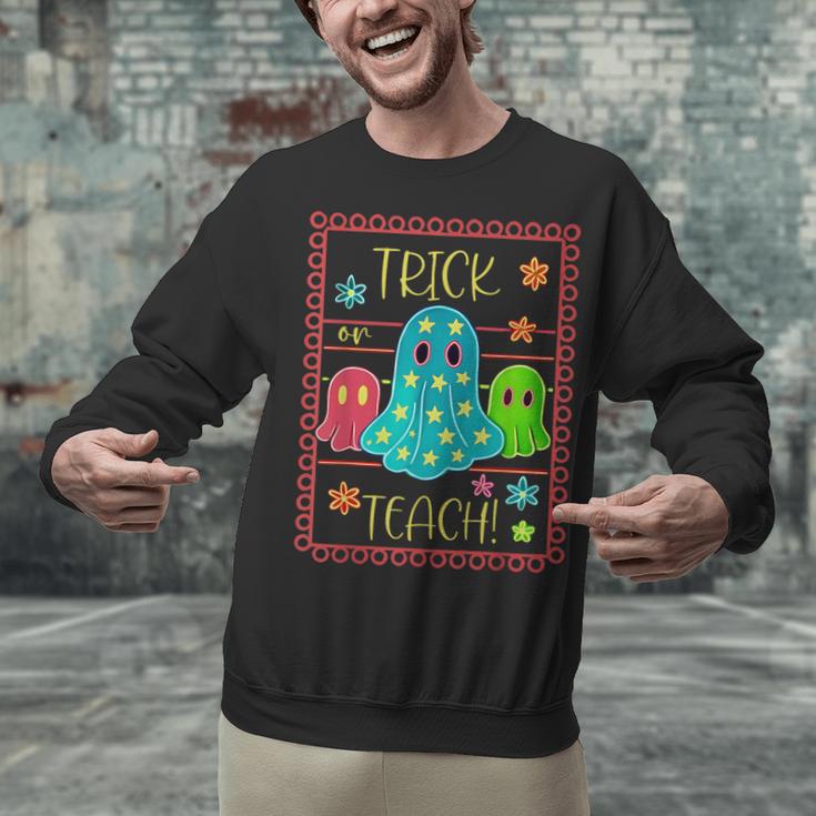 Trick Or Teach Neon Ghost Flower Teacher Spooky Halloween Unisex Sweatshirt, gift for family, gift for coworker Trick Or Teach Neon Ghost Flower Teacher Spooky Halloween Unisex Sweatshirt, gift for family, gift for coworker