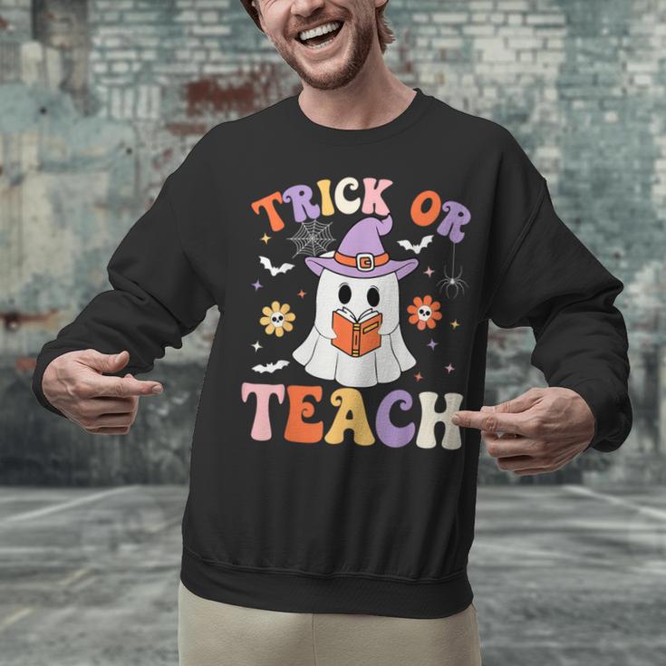 Trick Or Teach Teacher Groovy Ghost Halloween Teacher Unisex Sweatshirt, Groovy Teacher Sweatshirts, gift for family, gift for coworker Trick Or Teach Teacher Groovy Ghost Halloween Teacher Unisex Sweatshirt, Groovy Teacher Sweatshirts, gift for family, gift for coworker