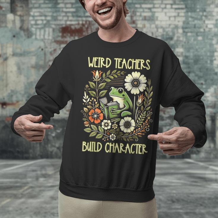 Weird Teachers Build Character Frog Reading Book Librarian Unisex Sweatshirt, gift for family, gift for coworker Weird Teachers Build Character Frog Reading Book Librarian Unisex Sweatshirt, gift for family, gift for coworker