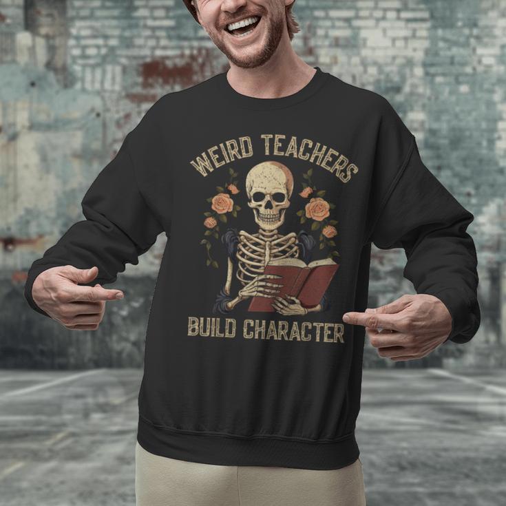 Weird Teachers Build Character Skeleton Book Halloween Women Unisex Sweatshirt, gift for family, gift for coworker Weird Teachers Build Character Skeleton Book Halloween Women Unisex Sweatshirt, gift for family, gift for coworker