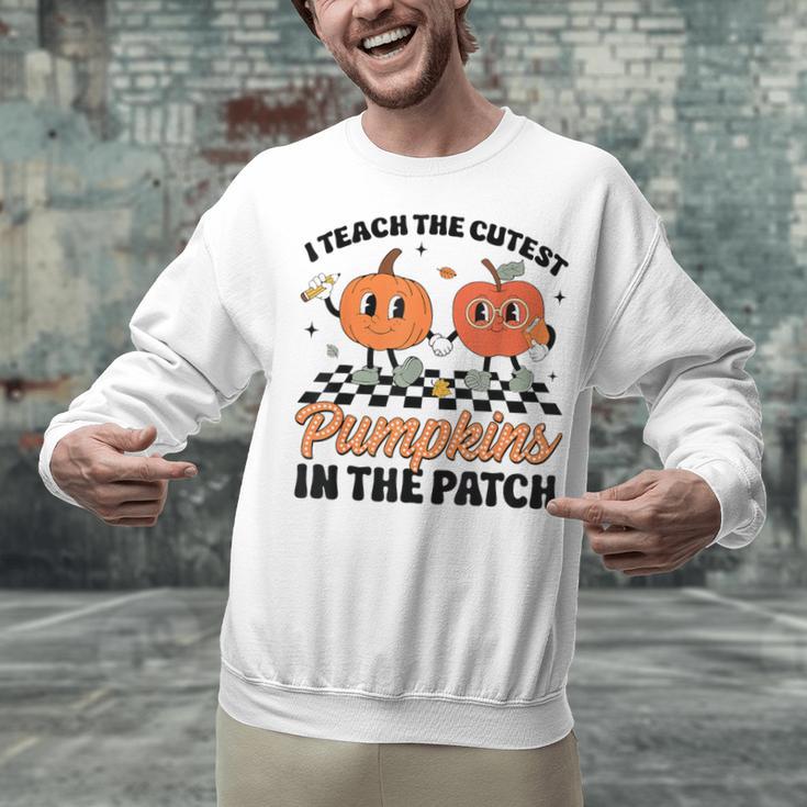 Groovy I Teach The Cutest Pumpkins In The Patch For Teacher Unisex Sweatshirt, Groovy Teacher Sweatshirts, gift for family, gift for coworker Groovy I Teach The Cutest Pumpkins In The Patch For Teacher Unisex Sweatshirt, Groovy Teacher Sweatshirts, gift for family, gift for coworker