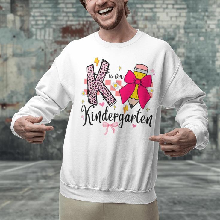 K Is For Kindergarten Teacher Coquette Bow Back To School Unisex Sweatshirt, gift for family, gift for coworker K Is For Kindergarten Teacher Coquette Bow Back To School Unisex Sweatshirt, gift for family, gift for coworker