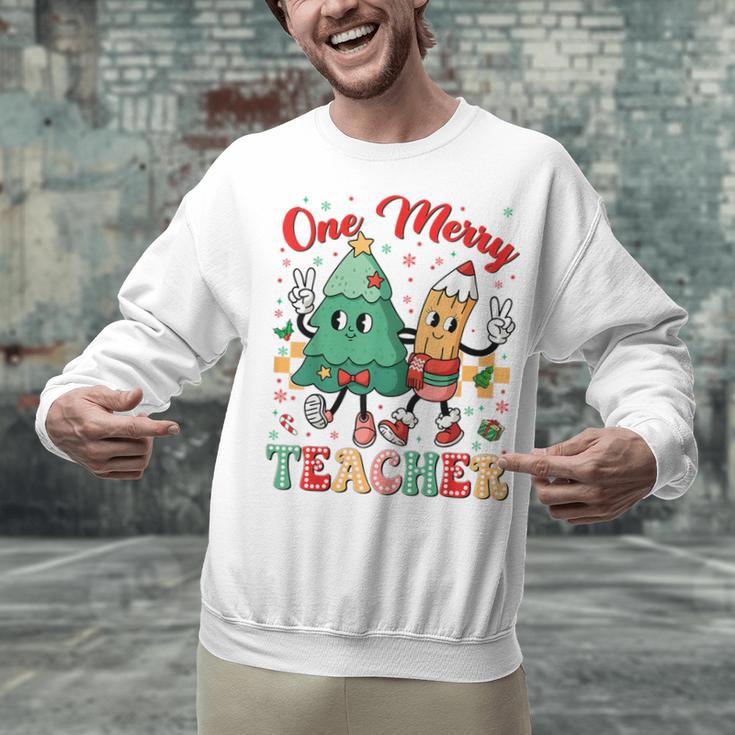 One Merry Teacher Groovy Christmas Tree Pjs Xmas Teacher Unisex Sweatshirt, Groovy Teacher Sweatshirts, gift for family, gift for coworker One Merry Teacher Groovy Christmas Tree Pjs Xmas Teacher Unisex Sweatshirt, Groovy Teacher Sweatshirts, gift for family, gift for coworker