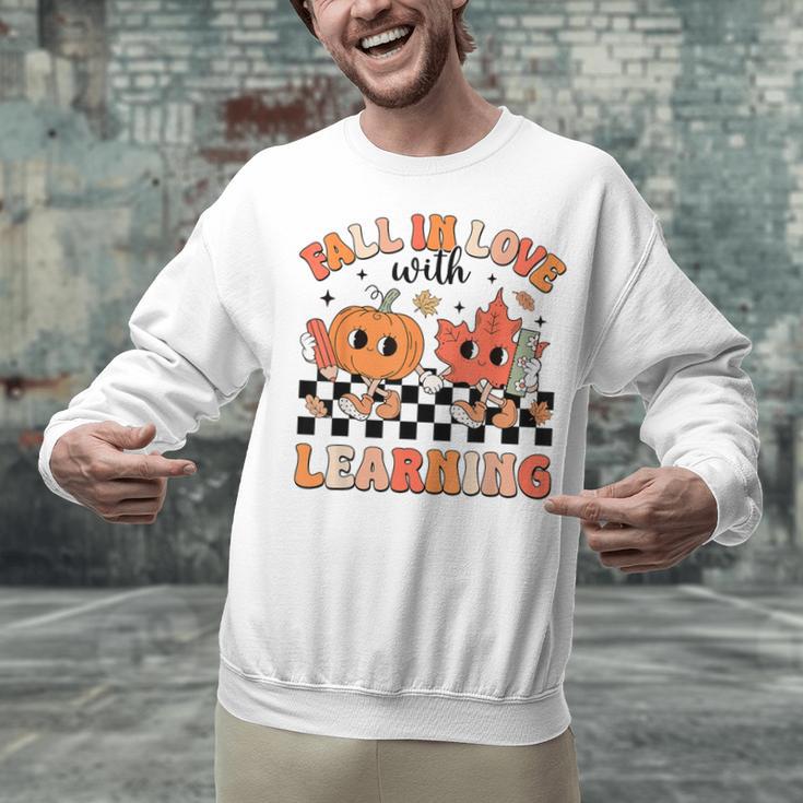 Retro Fall In Love With Learning Autumn Pumpkin Teacher Unisex Sweatshirt, gift for family, gift for coworker Retro Fall In Love With Learning Autumn Pumpkin Teacher Unisex Sweatshirt, gift for family, gift for coworker