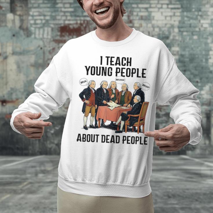 I Teach Young People About Dead-People History Teachers Unisex Sweatshirt, History Teacher Sweatshirts, gift for family, gift for coworker I Teach Young People About Dead-People History Teachers Unisex Sweatshirt, History Teacher Sweatshirts, gift for family, gift for coworker