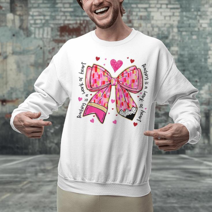 Teaching Is A Work Of Heart Pencil Bow Teacher Valentine Unisex Sweatshirt, gift for family, gift for coworker Teaching Is A Work Of Heart Pencil Bow Teacher Valentine Unisex Sweatshirt, gift for family, gift for coworker