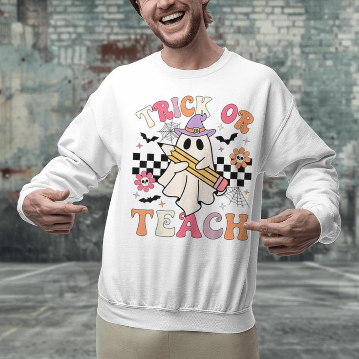 Trick Or Teach Groovy Teacher Halloween Retro Floral Ghost Unisex Sweatshirt, Groovy Teacher Sweatshirts, gift for family, gift for coworker Trick Or Teach Groovy Teacher Halloween Retro Floral Ghost Unisex Sweatshirt, Groovy Teacher Sweatshirts, gift for family, gift for coworker