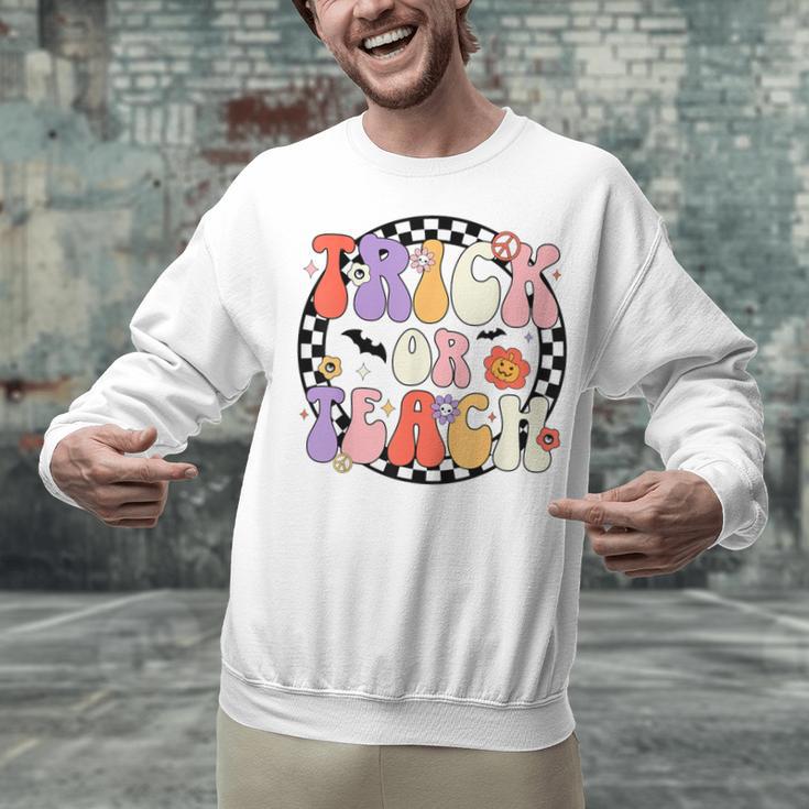 Trick Or Teach Retro Groovy Halloween Teacher Unisex Sweatshirt, Groovy Teacher Sweatshirts, gift for family, gift for coworker Trick Or Teach Retro Groovy Halloween Teacher Unisex Sweatshirt, Groovy Teacher Sweatshirts, gift for family, gift for coworker