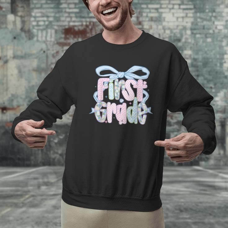 First Grade Coquette Bow Girls Teacher Team 1st Grade Squad Men Graphic Sweatshirt, First Grade Teacher Sweatshirts, gift for family, gift for coworker First Grade Coquette Bow Girls Teacher Team 1st Grade Squad Men Graphic Sweatshirt, First Grade Teacher Sweatshirts, gift for family, gift for coworker