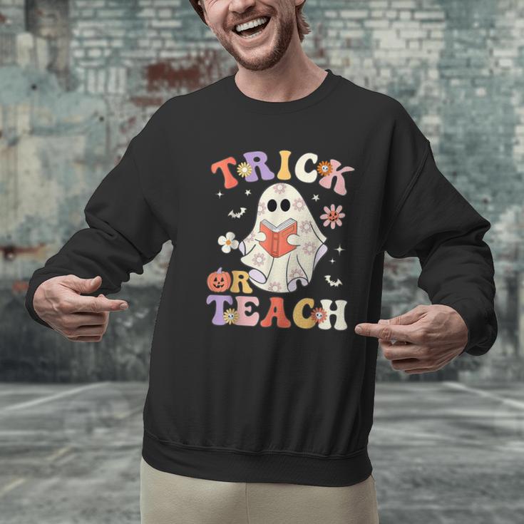 Groovy Halloween Trick Or Teach Retro Floral Ghost Teacher Men Graphic Sweatshirt, Groovy Teacher Sweatshirts, gift for family, gift for coworker Groovy Halloween Trick Or Teach Retro Floral Ghost Teacher Men Graphic Sweatshirt, Groovy Teacher Sweatshirts, gift for family, gift for coworker
