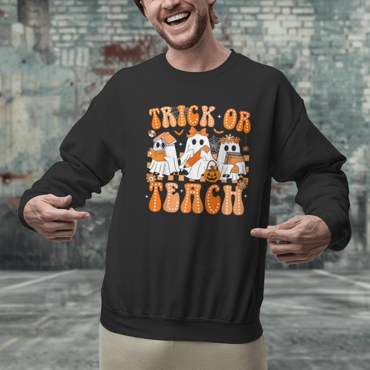 Groovy Teacher Halloween Trick Or Teach Ghost Men Women Kids Men Graphic Sweatshirt, Groovy Teacher Sweatshirts, gift for family, gift for coworker Groovy Teacher Halloween Trick Or Teach Ghost Men Women Kids Men Graphic Sweatshirt, Groovy Teacher Sweatshirts, gift for family, gift for coworker