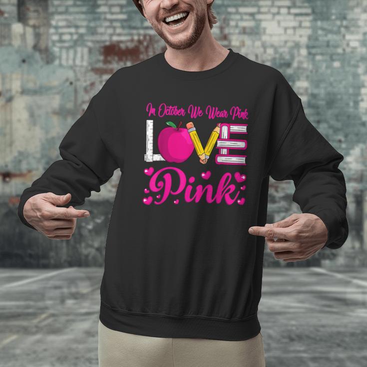 In October We Wear Pink Love Teacher Breast Cancer Awareness Men Graphic Sweatshirt, gift for family, gift for coworker In October We Wear Pink Love Teacher Breast Cancer Awareness Men Graphic Sweatshirt, gift for family, gift for coworker