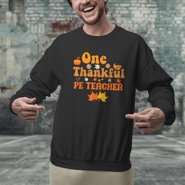 One Thankful PE Teacher Thanksgiving Fall Autumn Groovy Men Graphic Sweatshirt, Pe Teacher Sweatshirts, Groovy Teacher Sweatshirts, gift for family, gift for coworker One Thankful PE Teacher Thanksgiving Fall Autumn Groovy Men Graphic Sweatshirt, Pe Teacher Sweatshirts, Groovy Teacher Sweatshirts, gift for family, gift for coworker