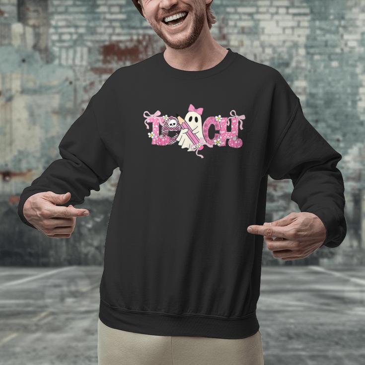 Pink Ghost Teach Halloween Teacher In Spooky Season Men Graphic Sweatshirt, gift for family, gift for coworker Pink Ghost Teach Halloween Teacher In Spooky Season Men Graphic Sweatshirt, gift for family, gift for coworker