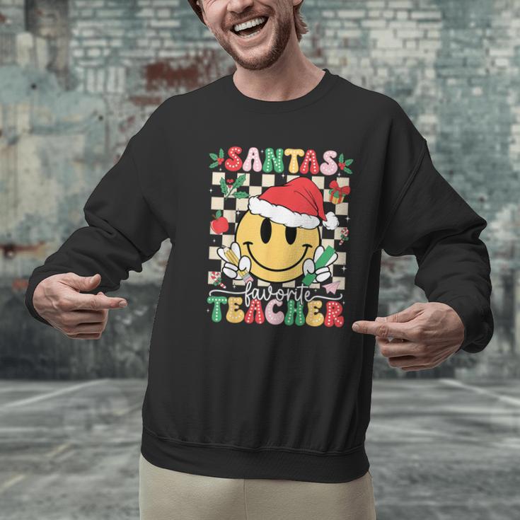 Santas Favorite Teacher Retro Groovy Smile Face Christmas Men Graphic Sweatshirt, Groovy Teacher Sweatshirts, gift for family, gift for coworker