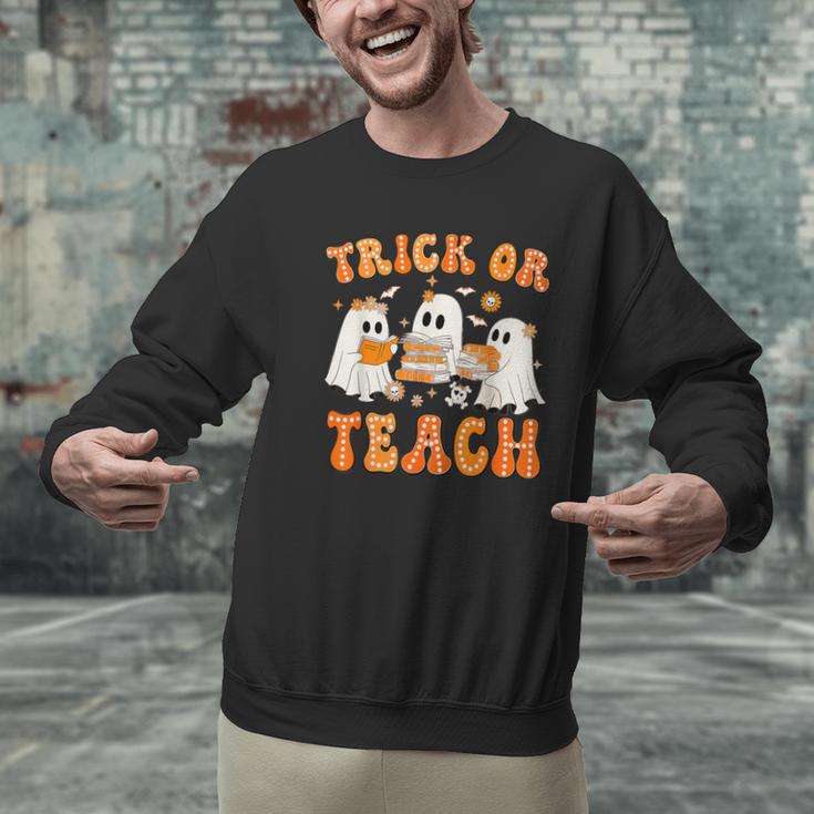 Teacher Halloween Trick Or Teach Retro Groovy Floral Ghost Men Graphic Sweatshirt, Groovy Teacher Sweatshirts, gift for family, gift for coworker Teacher Halloween Trick Or Teach Retro Groovy Floral Ghost Men Graphic Sweatshirt, Groovy Teacher Sweatshirts, gift for family, gift for coworker