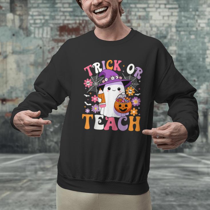 Trick Or Teach Groovy Teacher Ghost Halloween Teacher Men Graphic Sweatshirt, Groovy Teacher Sweatshirts, gift for family, gift for coworker Trick Or Teach Groovy Teacher Ghost Halloween Teacher Men Graphic Sweatshirt, Groovy Teacher Sweatshirts, gift for family, gift for coworker