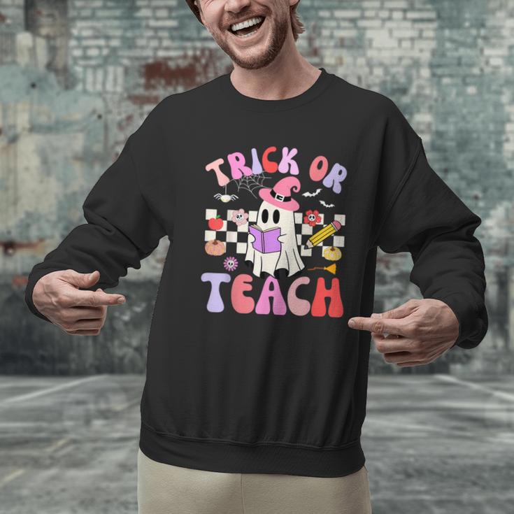 Trick Or Teach Halloween Teacher Floral Ghost Groovy Men Graphic Sweatshirt, Groovy Teacher Sweatshirts, gift for family, gift for coworker Trick Or Teach Halloween Teacher Floral Ghost Groovy Men Graphic Sweatshirt, Groovy Teacher Sweatshirts, gift for family, gift for coworker
