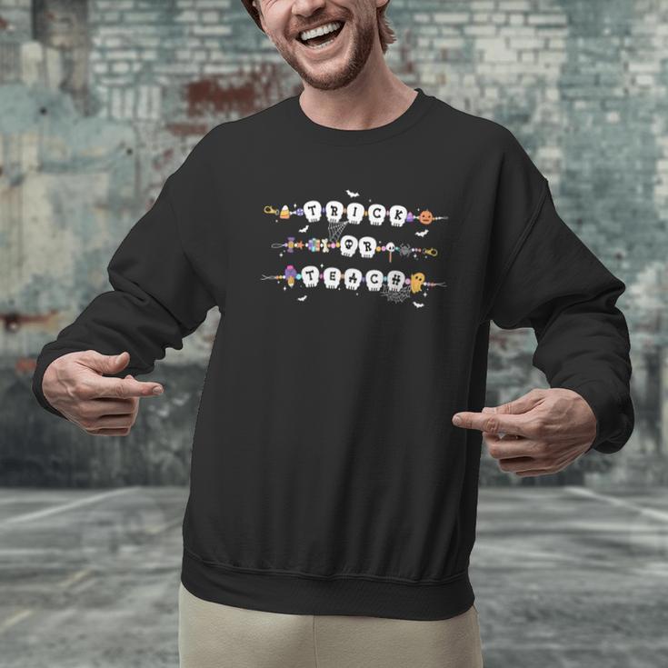 Trick Or Teach Spooky Teacher Happy Halloween Bracelet Men Graphic Sweatshirt, gift for family, gift for coworker Trick Or Teach Spooky Teacher Happy Halloween Bracelet Men Graphic Sweatshirt, gift for family, gift for coworker